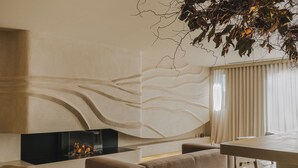 Un salon moderne avec une cheminée, un canapé et un coin repas.