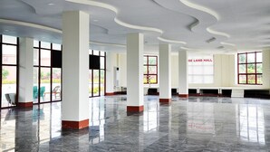 A spacious lobby with high ceilings, large windows, and a polished marble floor. - Rose Land Apartment Hotel (Naypyidaw)