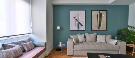 A modern living room with a sofa, a coffee table, and a floor lamp.