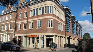A corner building with a storefront labeled "Sainsbury's Local." - Churchill Apartments (York)