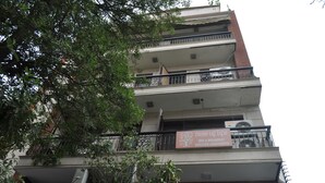 A multi-story building with a sign for 'Tree of Life Bed & Breakfast' offering serviced apartments. - OYO Premium Saket Metro Station (New Delhi)
