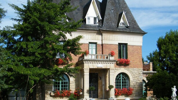 A large, historic house with a prominent tower, a well-maintained garden, and a welcoming entrance. - Villa des Iris (Saint-Felix)