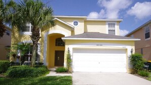 A two-story house with a garage, a front porch, and a well-maintained lawn. - Ly53792 - Emerald Island - 6 Bed 5 Baths Villa (Kissimmee)