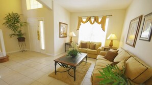 A living room with a sofa, a coffee table, and a potted plant. - Ly53792 - Emerald Island - 6 Bed 5 Baths Villa (Kissimmee)