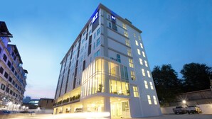Un hôtel moderne avec une façade en verre, de nombreux étages et un grand panneau indiquant « B2 ».