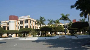 A hotel with a modern design, featuring a central courtyard with neatly trimmed trees and a clear sky. - The Prince Hotel Mandalay (Mandalay)