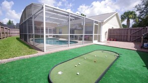 A backyard with a pool, a green artificial turf, and a pool table. - Ly53793 - Indian Ridge - 3 Bed 2 Baths Villa (Kissimmee)