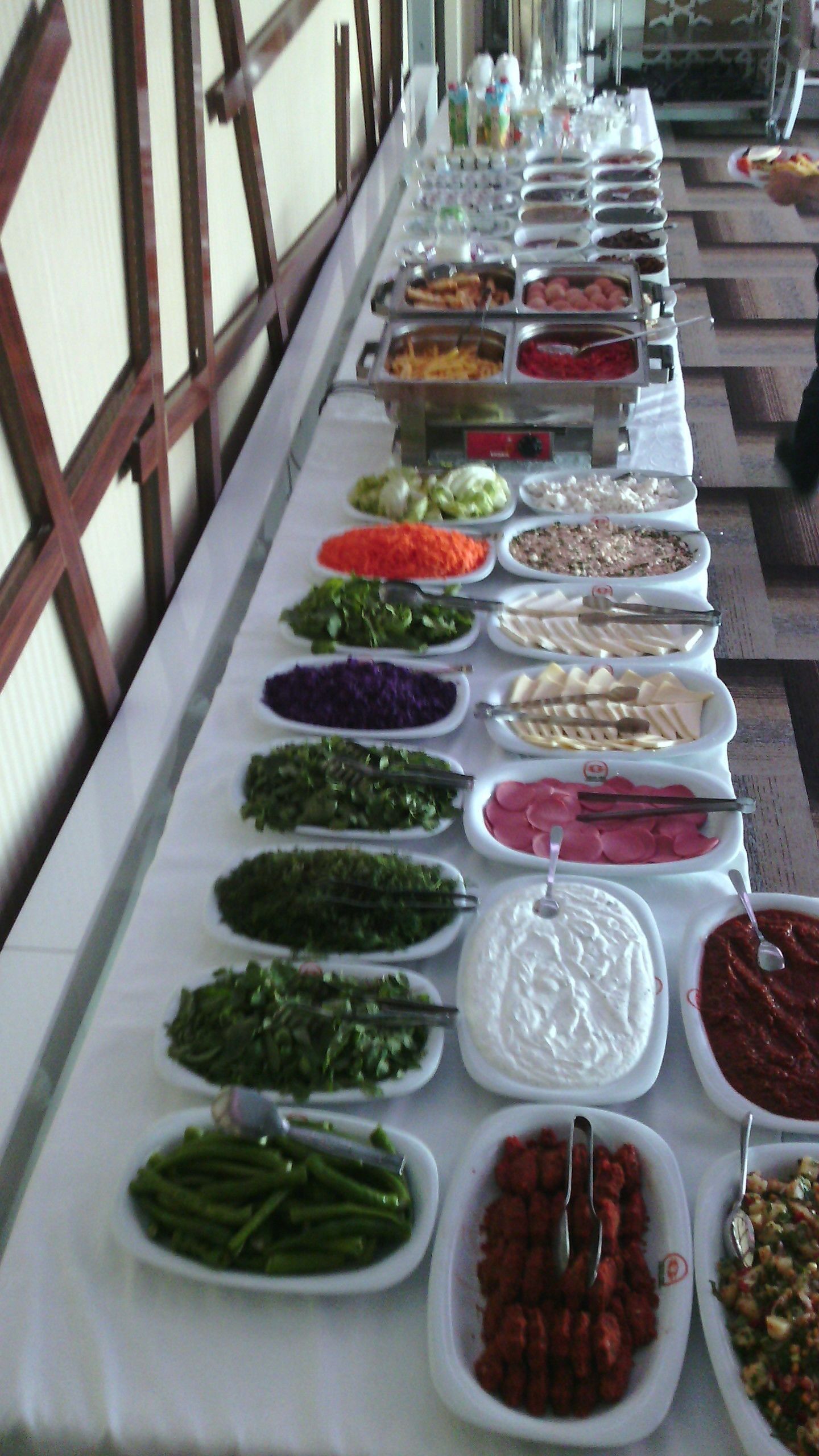A buffet table with various dishes.