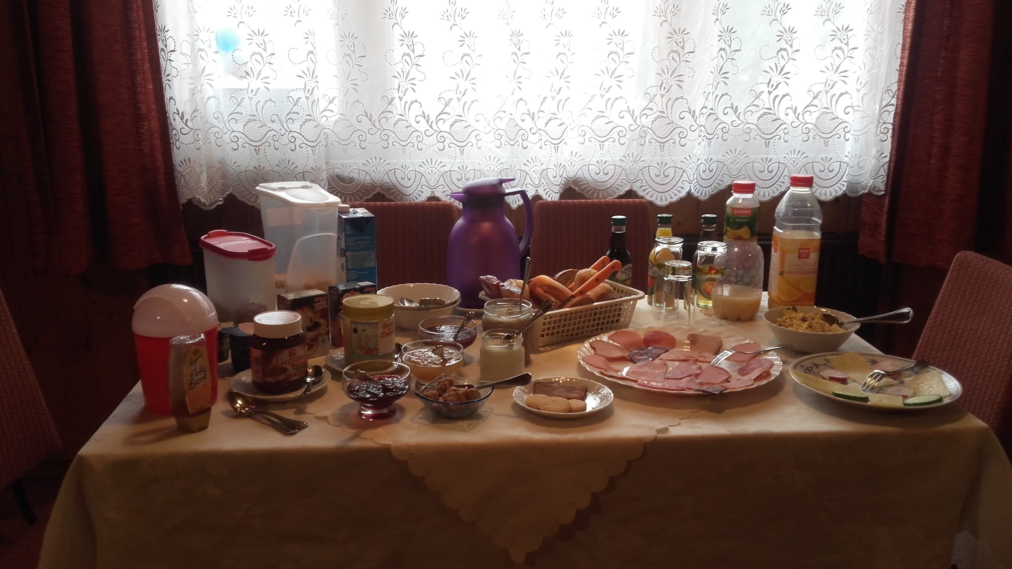 A table set for breakfast with various food items and condiments.