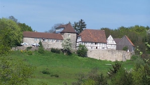 A historic building with a stone facade, a tower, and a mix of traditional and modern architectural styles.