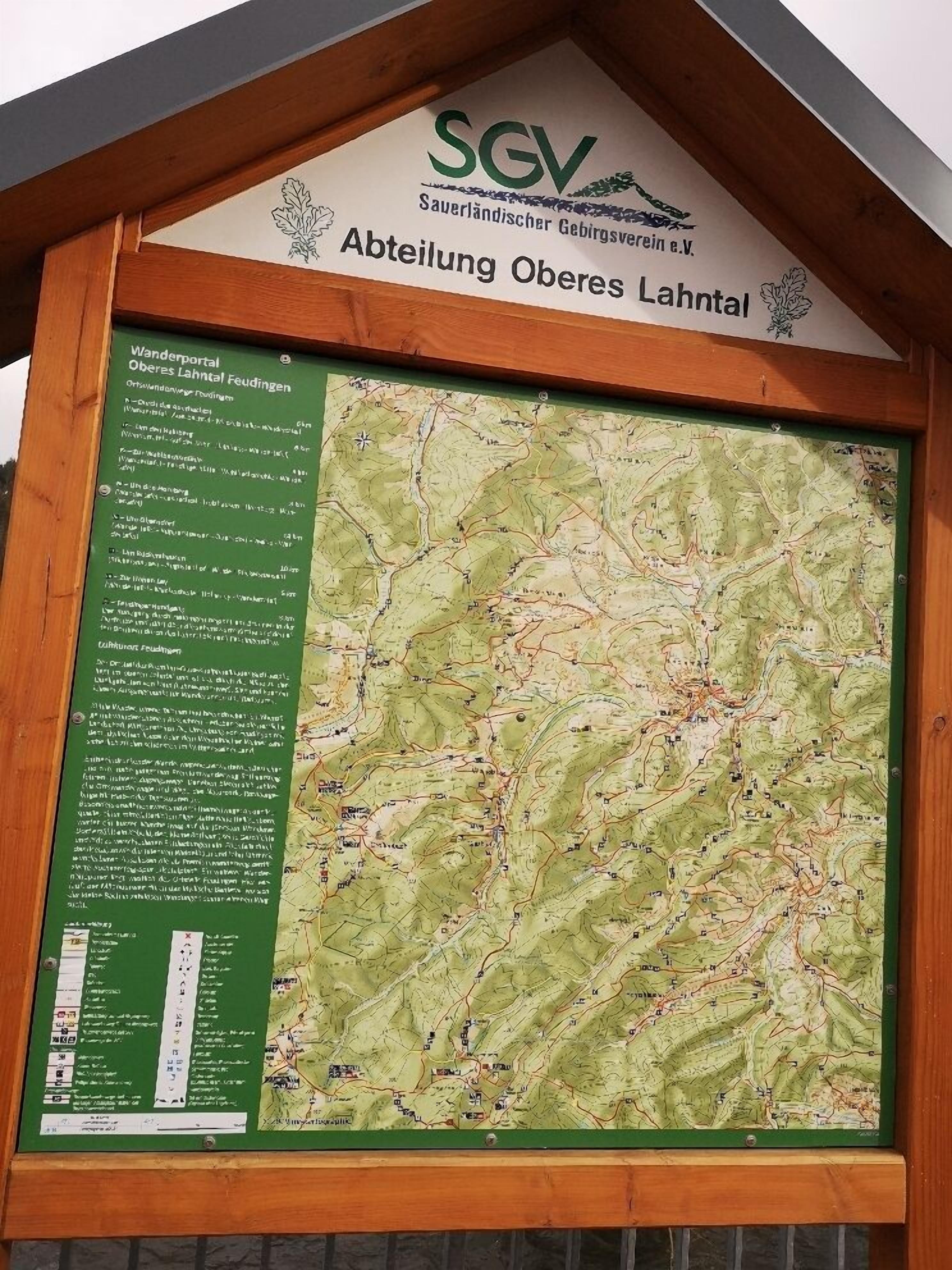 A detailed hiking map with a wooden frame and signage for Oberes Lahntal.