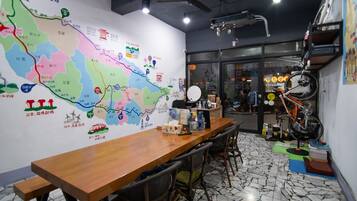 A conference room with a large map on the wall, a wooden table, and chairs.