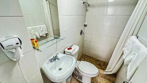 A bathroom with a white sink, a toilet, and a glass shelf. - Gladiolas 2101 (Ponce)