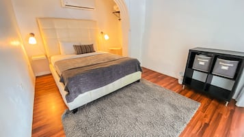 Cozy retreat with a single bed, tufted headboard, and wardrobe.