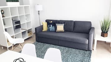 Studio, Multiple Beds | Living area | Flat-screen TV