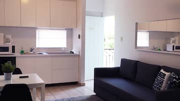 Apartment, 1 Bedroom | Living area | Flat-screen TV