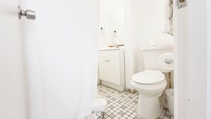 A small, white bathroom with a toilet, sink, and cabinet. - Aibonito Hotel 208 (Aibonito)