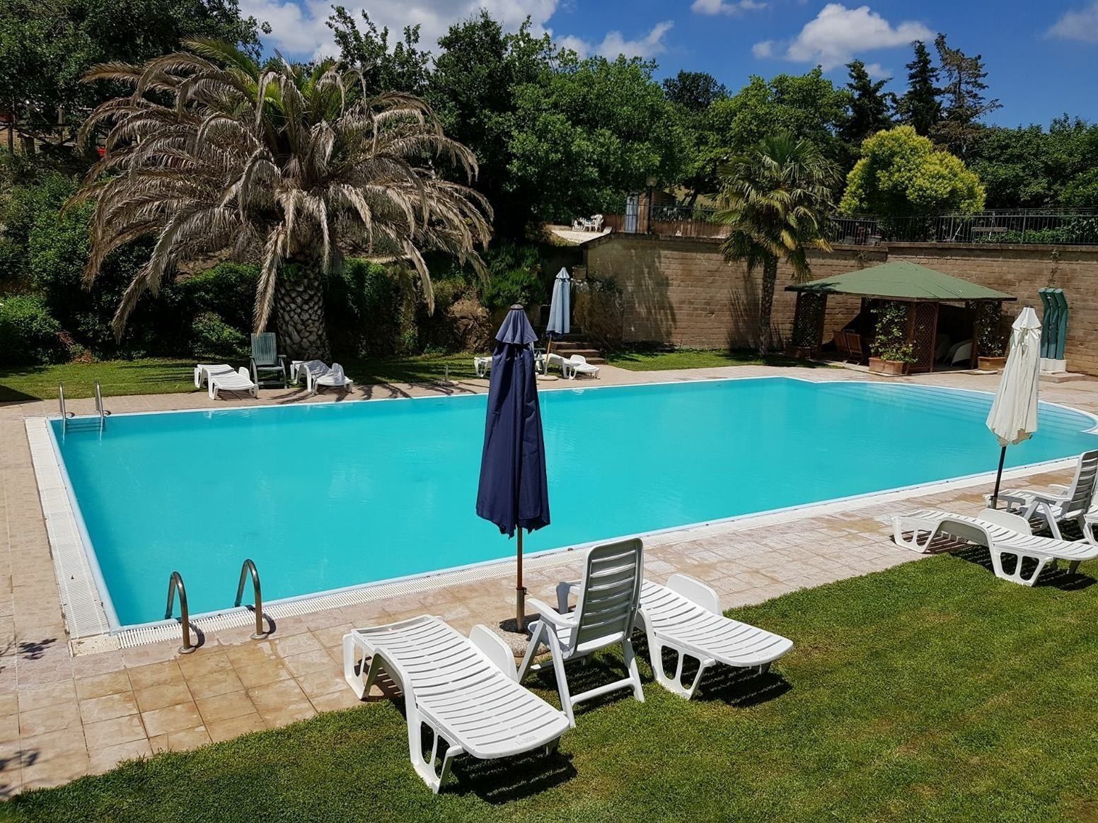 Outdoor pool, open 9 AM to 8 PM, pool umbrellas, pool loungers