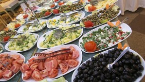 A buffet with various dishes including salads, fruits, and vegetables. - Aykut Palace Otel (Iskenderun)