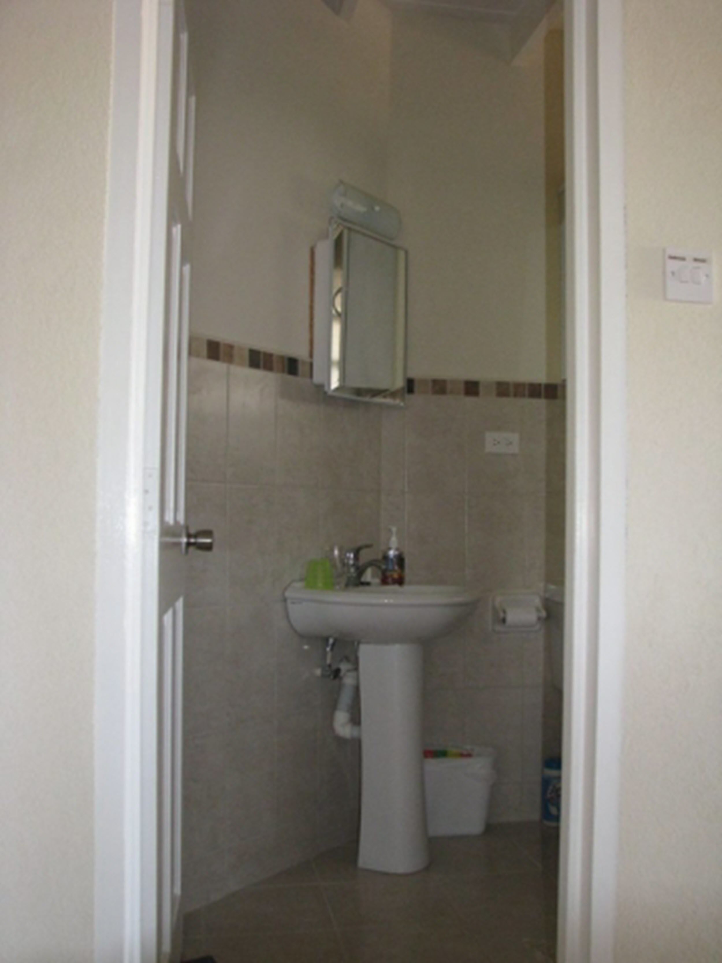 A bathroom with a sink, mirror, and toilet.