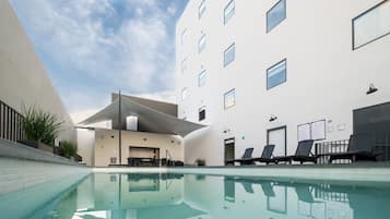 Outdoor pool, open 7 AM to 10 PM, pool loungers