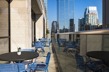 A poolside area with a ceiling fan, seating, and a 3 FT depth pool. at Holiday Inn & Suites Nashville Downtown - Broadway by IHG