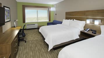 A hotel room with two beds, a desk, a chair, a TV, and a window with a view.
