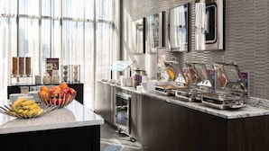 A modern breakfast bar with fruit bowls, a coffee station, and a refrigerated display. - Residence Inn by Marriott Boston Downtown / South End (Boston)
