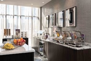 A modern breakfast bar with fruit bowls, a coffee station, and a refrigerated display. - Residence Inn by Marriott Boston Downtown / South End (Boston)