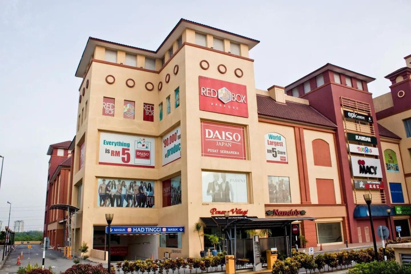 A multi-story commercial building with various retail stores including Red Box Karaoke, Daisho Japan, and Macy's.