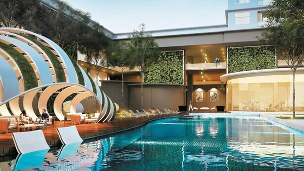 A modern hotel with a swimming pool, lounge area, and a unique architectural design. - Skypod (Puchong)