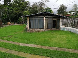 A small house with a sloped roof, a front door, and a window. - Jungla de Panama (Palmira)