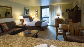 A hotel room with a bed, a sofa, a desk, and a dining table. - 3160 Aspen Grove (Truckee)