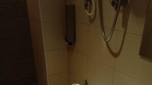 A bathroom with a toilet, a sink, and a shower. - Sovotel 9 Puchong (Puchong)