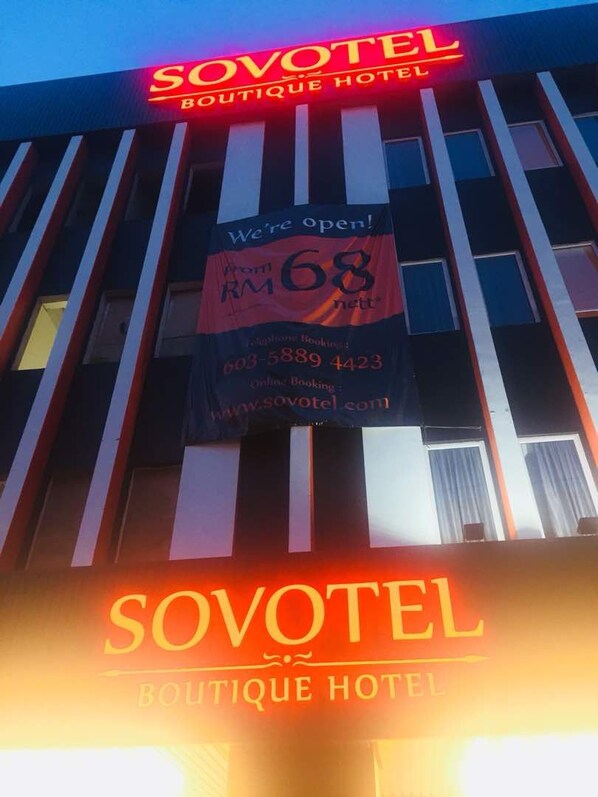 The exterior of the Sovotel Boutique Hotel with a prominent sign indicating the price per night and contact information. - Sovotel 9 Puchong (Puchong)