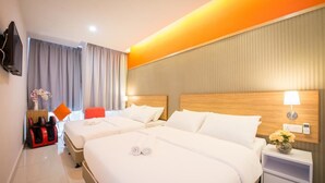 A hotel room with two beds, a massage chair, a TV, and a nightstand with a lamp. - Sovotel 9 Puchong (Puchong)