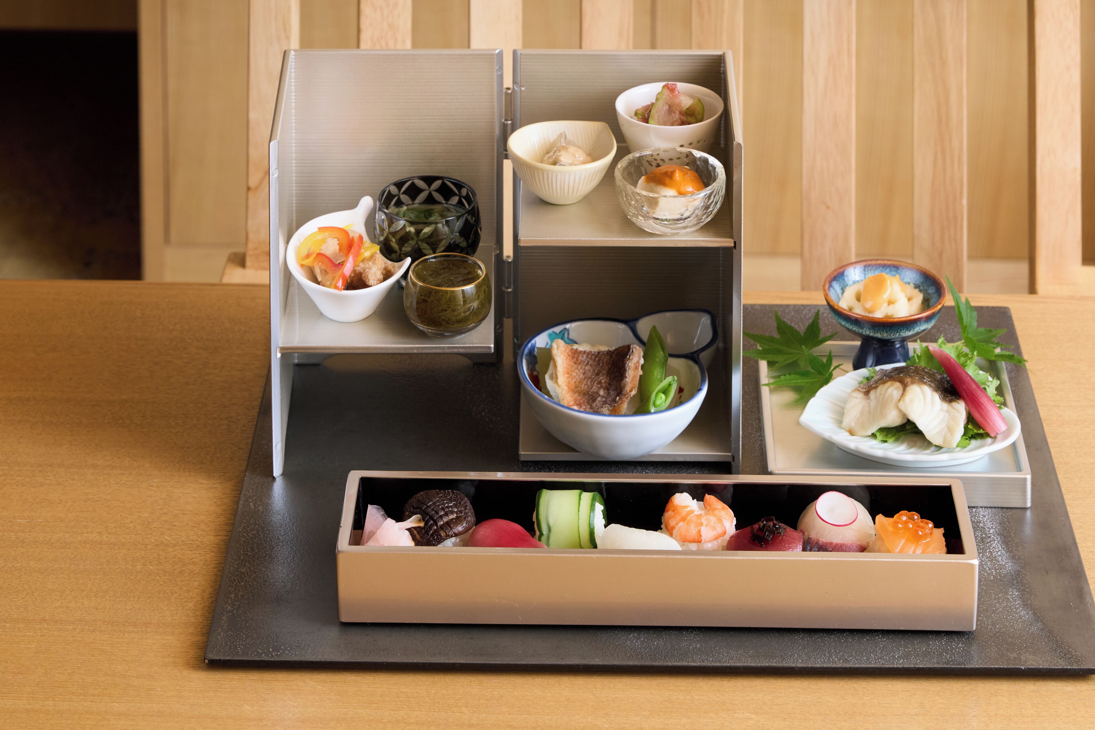 A traditional Japanese bento box with various food items.