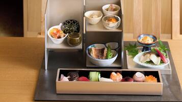 A traditional Japanese bento box with various food items.