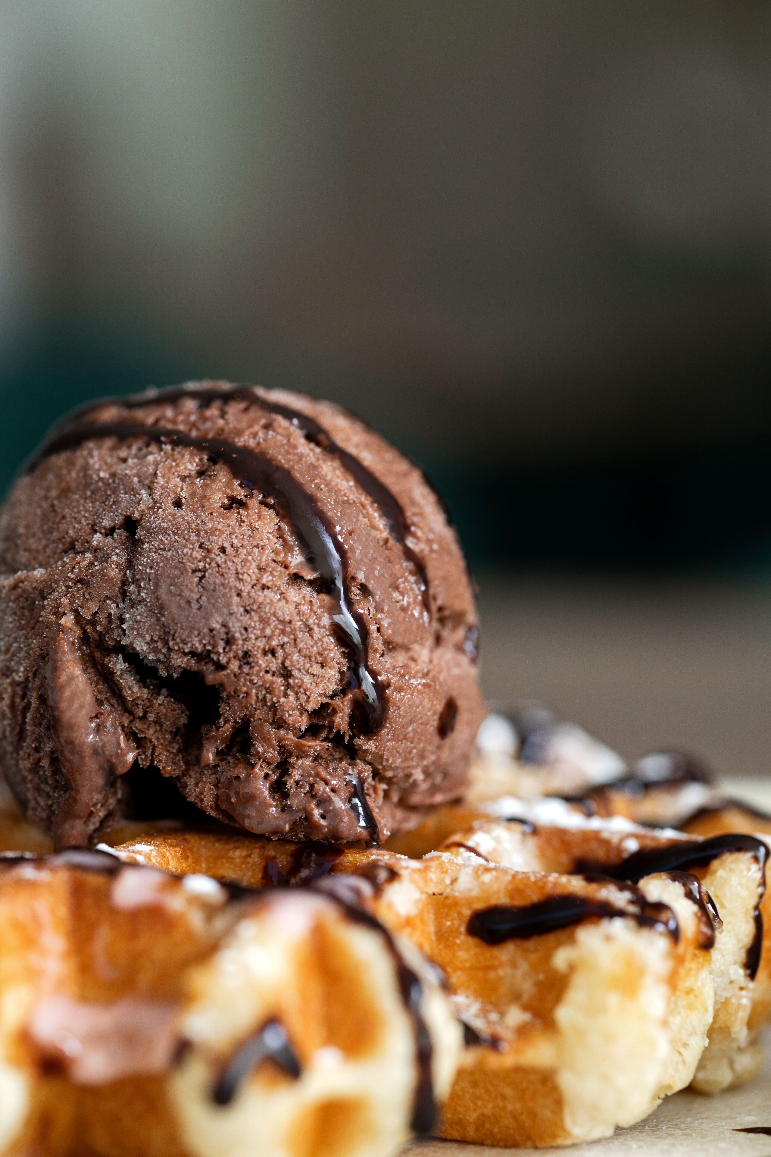 A dessert with chocolate ice cream and chocolate drizzle on a pastry.