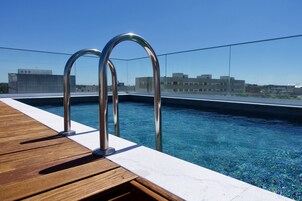 Seasonal outdoor pool, open 9 AM to 8 PM, pool umbrellas, sun loungers