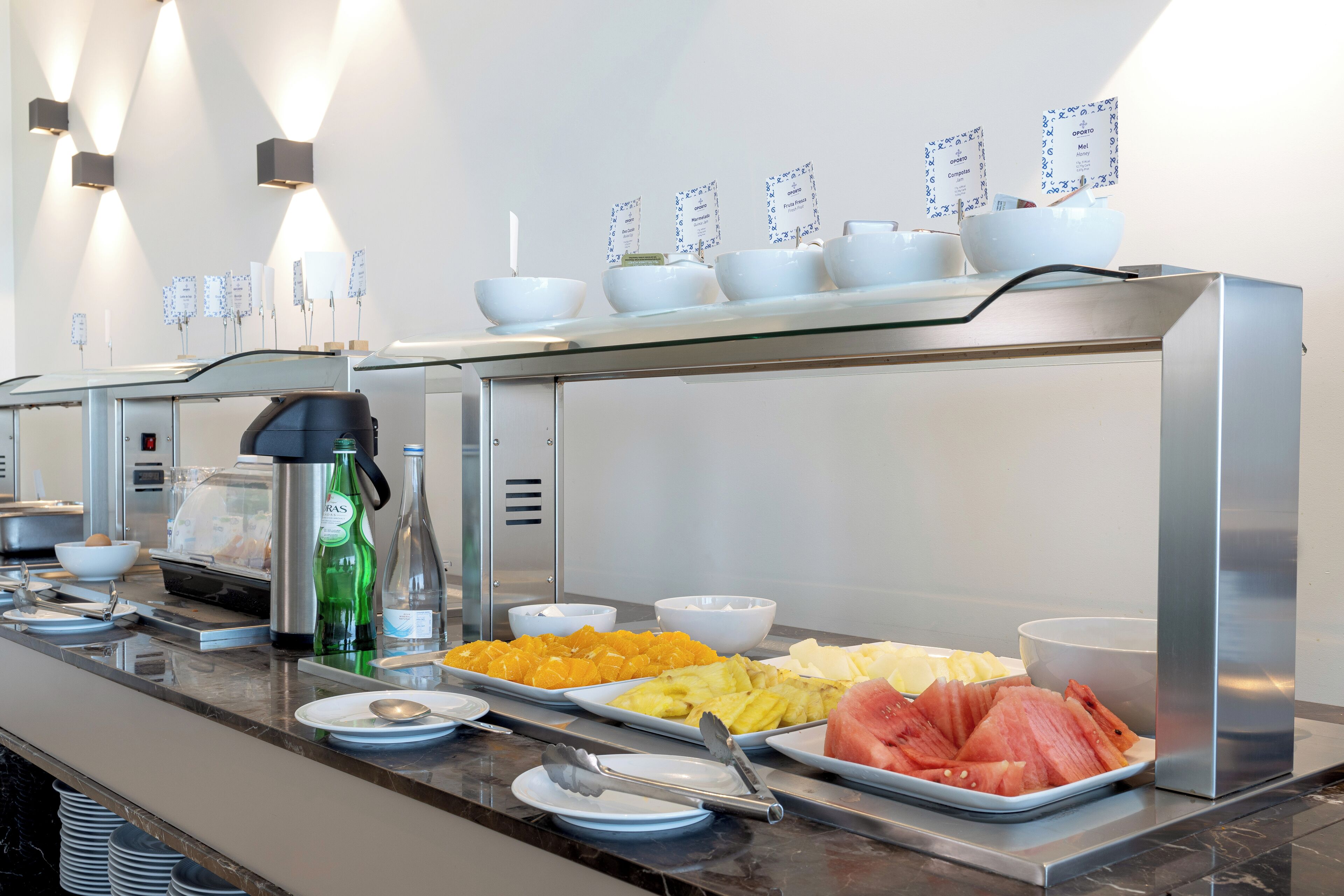 A buffet with various food items and condiments.