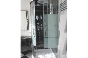 A modern bathroom with a glass enclosure, a white sink, and a towel rack. - Nido Dei Gabbiani (Naples)