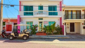 A two-story building with a sign reading "Villa Elena." - Villa Elena - Studio 1 (Isla Mujeres)