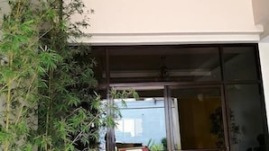A hotel entrance with a red carpet, a 'Welcome' sign, and a large glass door. - Castle Dreams Hotel (Davao)