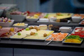 A buffet with various food items including meats, cheeses, and vegetables. - V Boutique Hotel (Boeblingen)