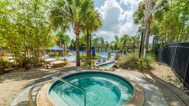 A swimming pool surrounded by palm trees and lounge chairs, with a stone pathway leading to it. - Ly53807 - Indian Ridge - 3 Bed 2 Baths Villa (Kissimmee)