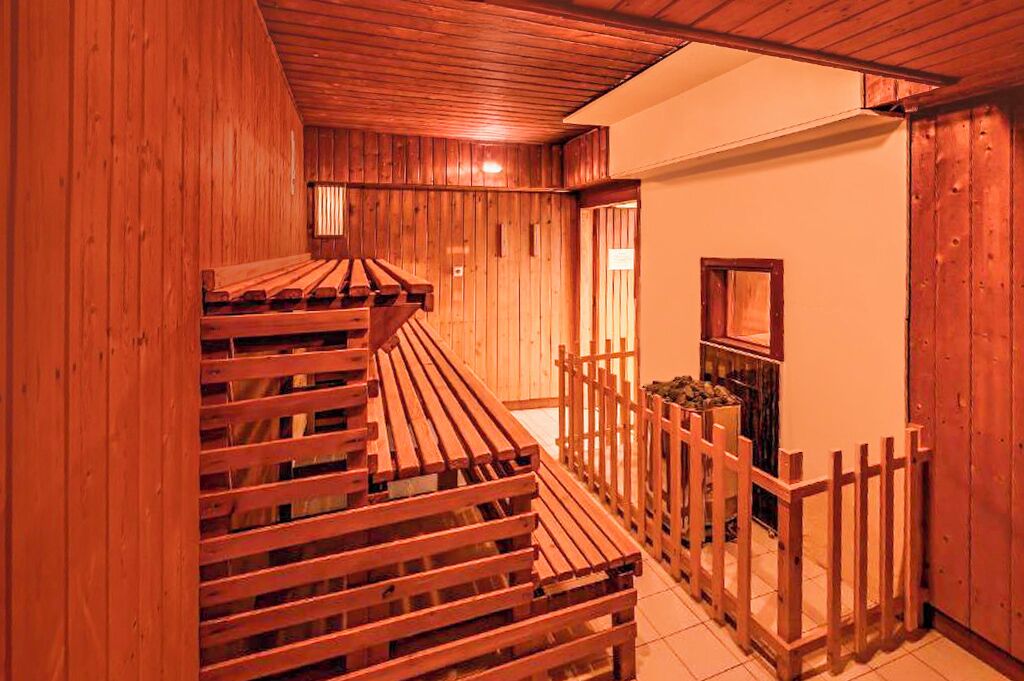 A wooden interior with a wooden staircase and a wooden fence.