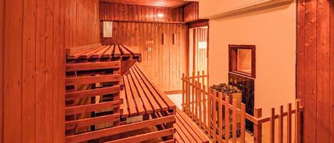 A wooden interior with a wooden staircase and a wooden fence.