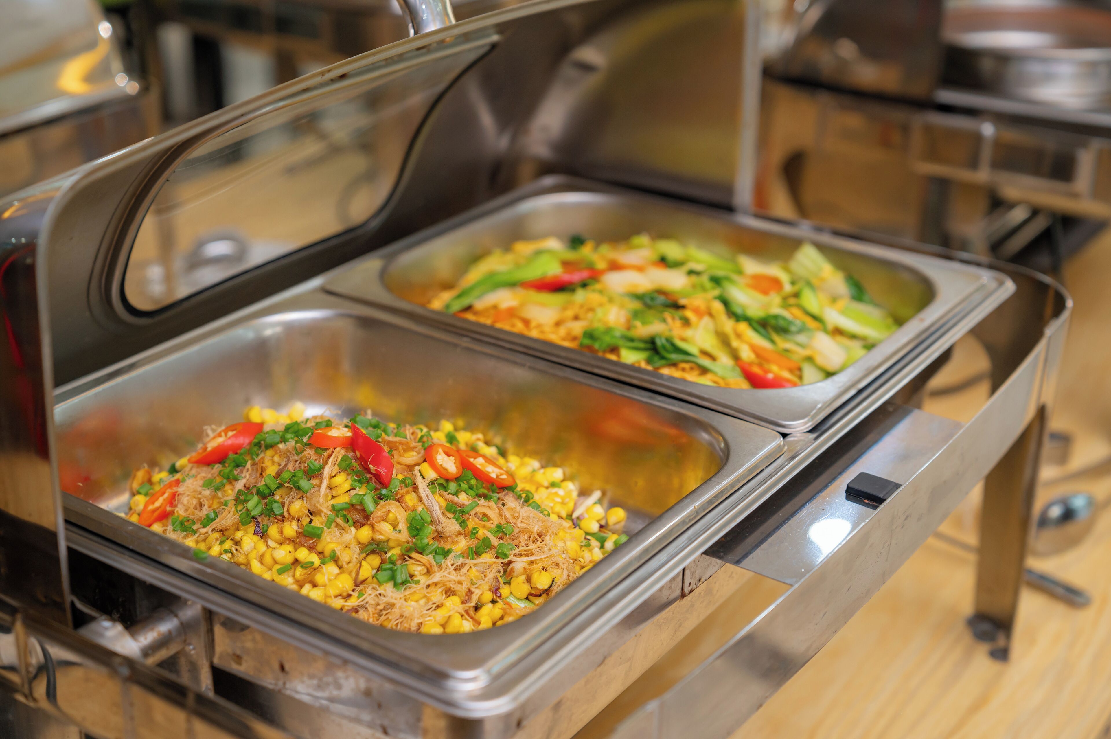 Ein Buffet mit zwei Bereichen, einer mit Mais und der andere mit Gemüse.