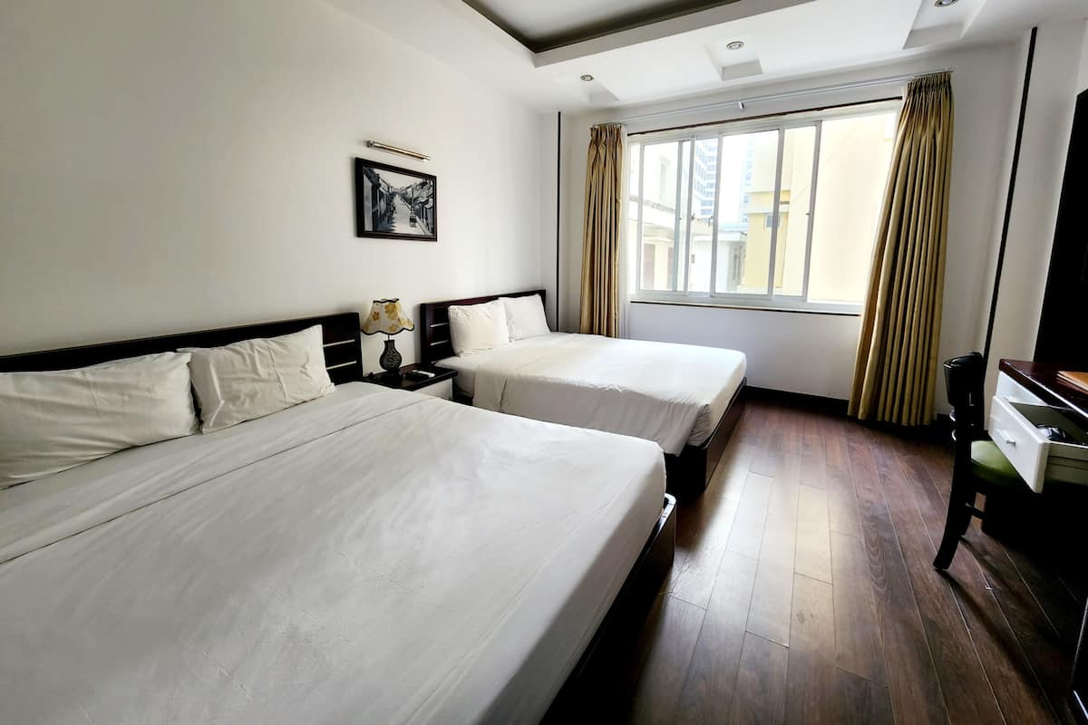 Deluxe Quadruple Room, City View | Hypo-allergenic bedding, down comforters, minibar, in-room safe